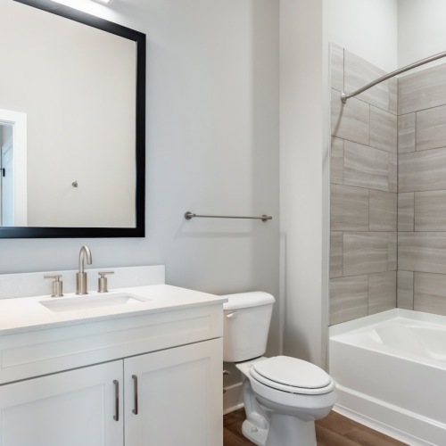 bathroom with sink mirror toilet and tub