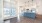 living room with wood flooring and view of the kitchen