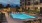 a pool with people walking around it